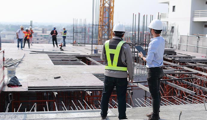 two engineers work on the construction site construction service